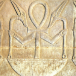 Ancient Egyptian relief carving depicting religious symbolism and hieroglyphs, representing the artistry and spiritual depth of Ancient Artz.