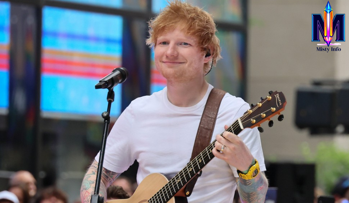 Ed Sheeran performing live with a smile during the launch of his new single “Azizam,” capturing the lovestruck jitters of his romantic pop song
