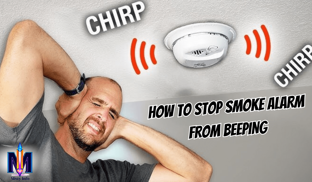 Frustrated man covering ears while smoke alarm beeps overhead — how to stop smoke alarm from beeping in the middle of the night